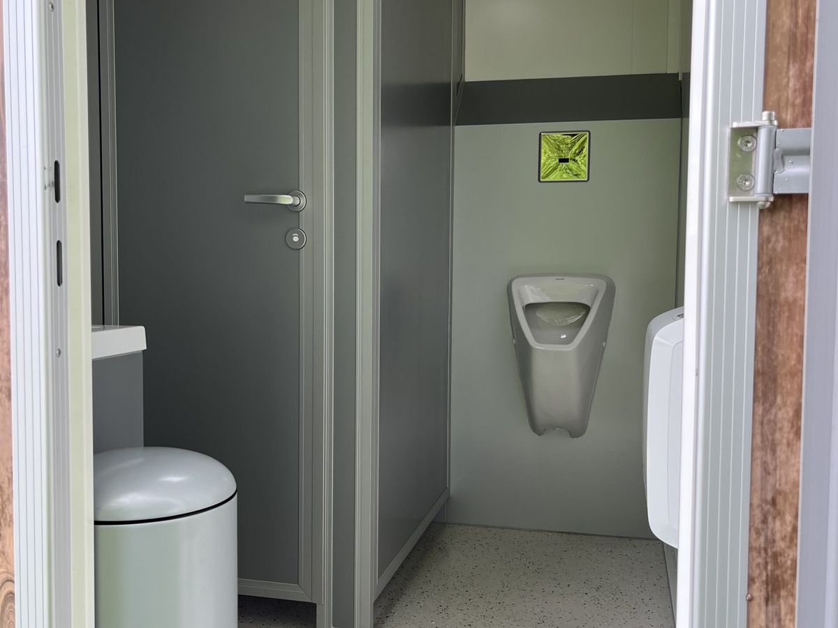 Blick in das Herrenabteil mit Urinal und Waschbecken